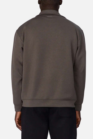 A person is shown from the back wearing the Industrie The Zip Thru Track Top in dark gray with black pants, made from soft fabric, against a plain light background.