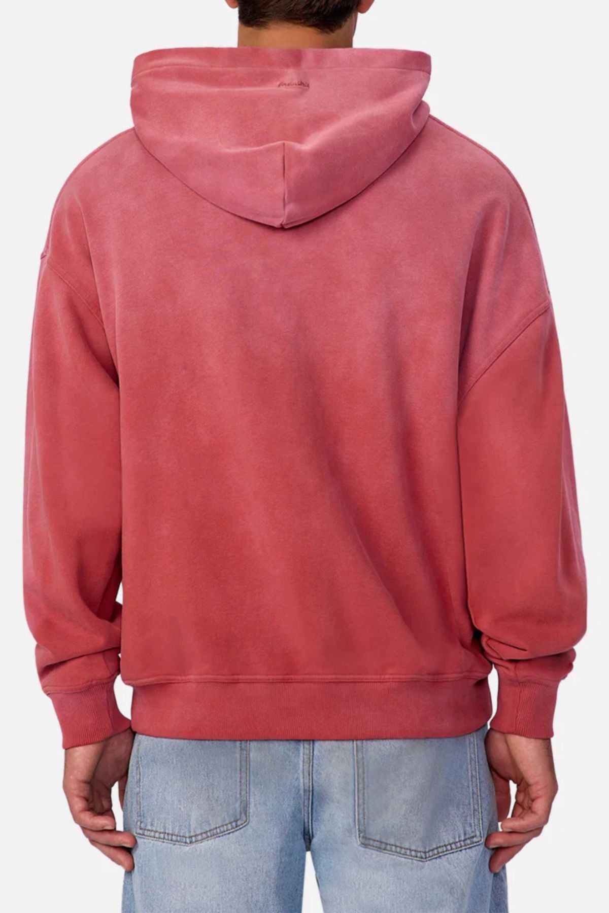 A person is seen from the back in a faded pink Industrie The Sandblast Hoodie and light blue jeans against a plain background, showcasing a relaxed look in 100% cotton comfort.
