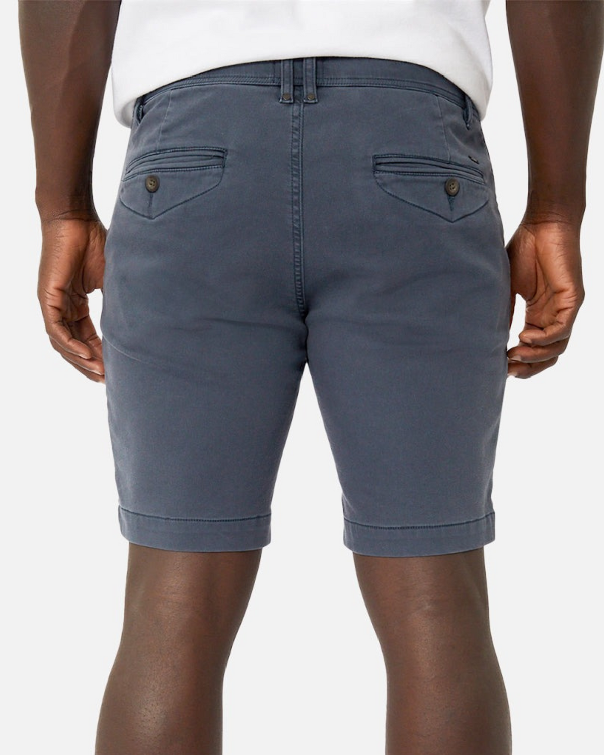 A person is shown from the back wearing a white shirt and Industrie The New Drifter Cuba Short, which features a belt loop waist, rolled hems, and two back pockets with buttoned flaps.