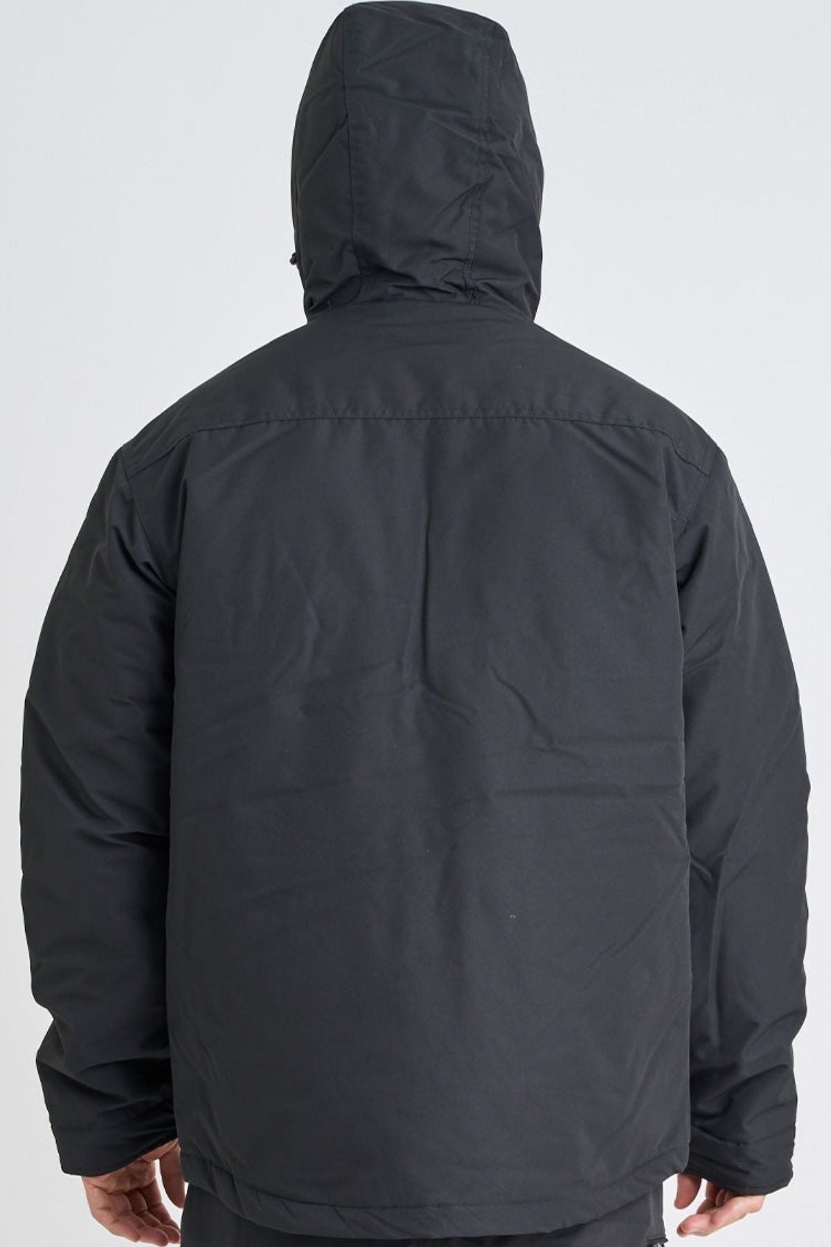 A person is seen from the back wearing a black Jetpilot Onsite Pro Jacket, standing against a plain light background.