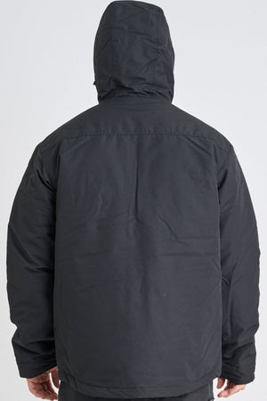 A person is seen from the back wearing a black Jetpilot Onsite Pro Jacket, standing against a plain light background.