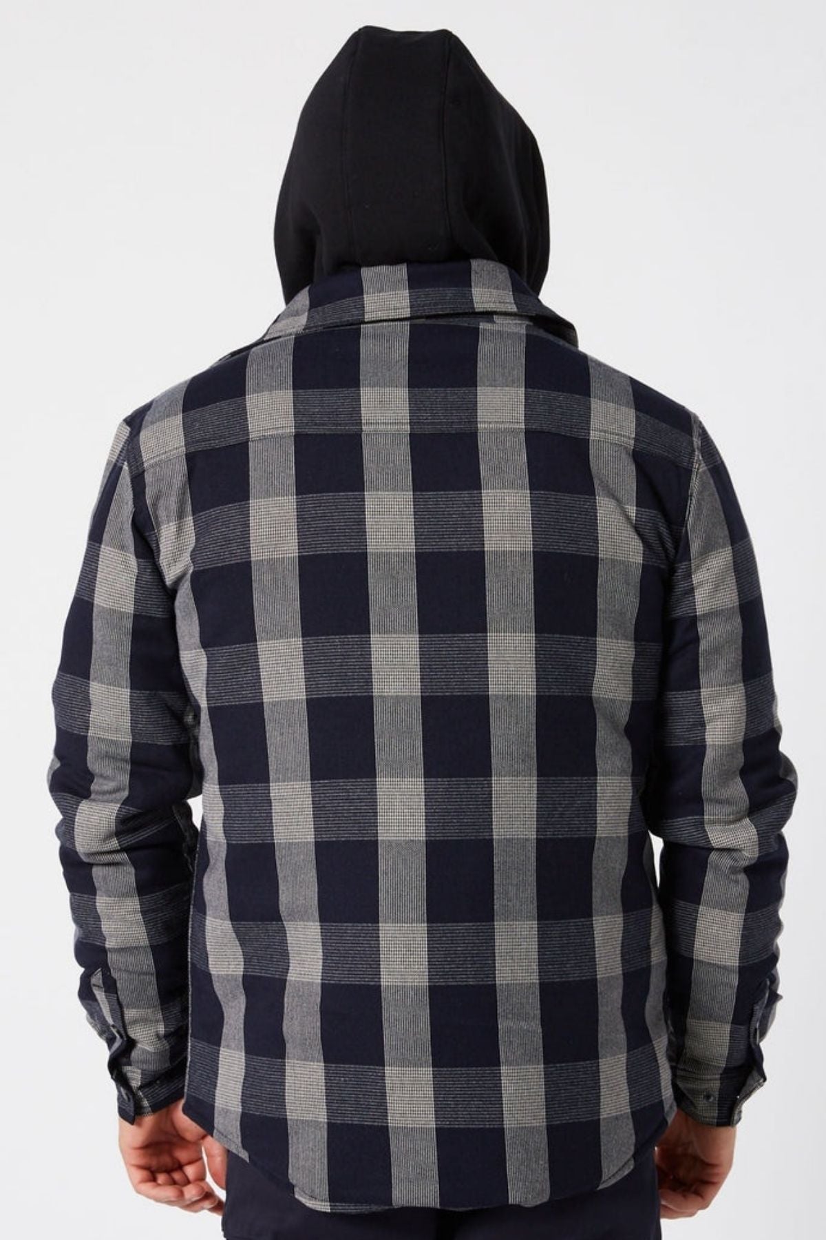 A person seen from the back, wearing a black hooded sweatshirt under a gray and black Jetpilot Quilted Flannel Jacket, against a plain light background.