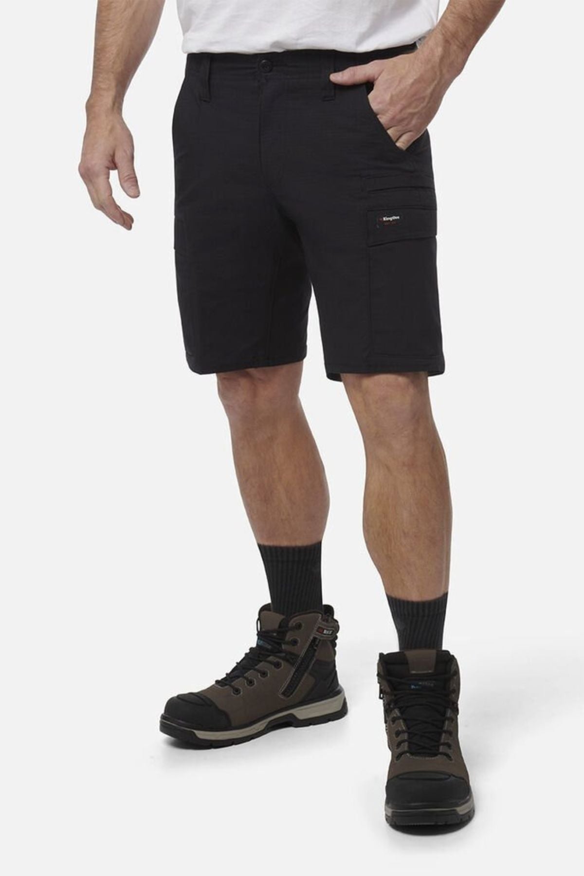 A man wearing black King Gee Workcool Pro Shorts, crafted from durable ripstop stretch fabric, paired with matching black socks.