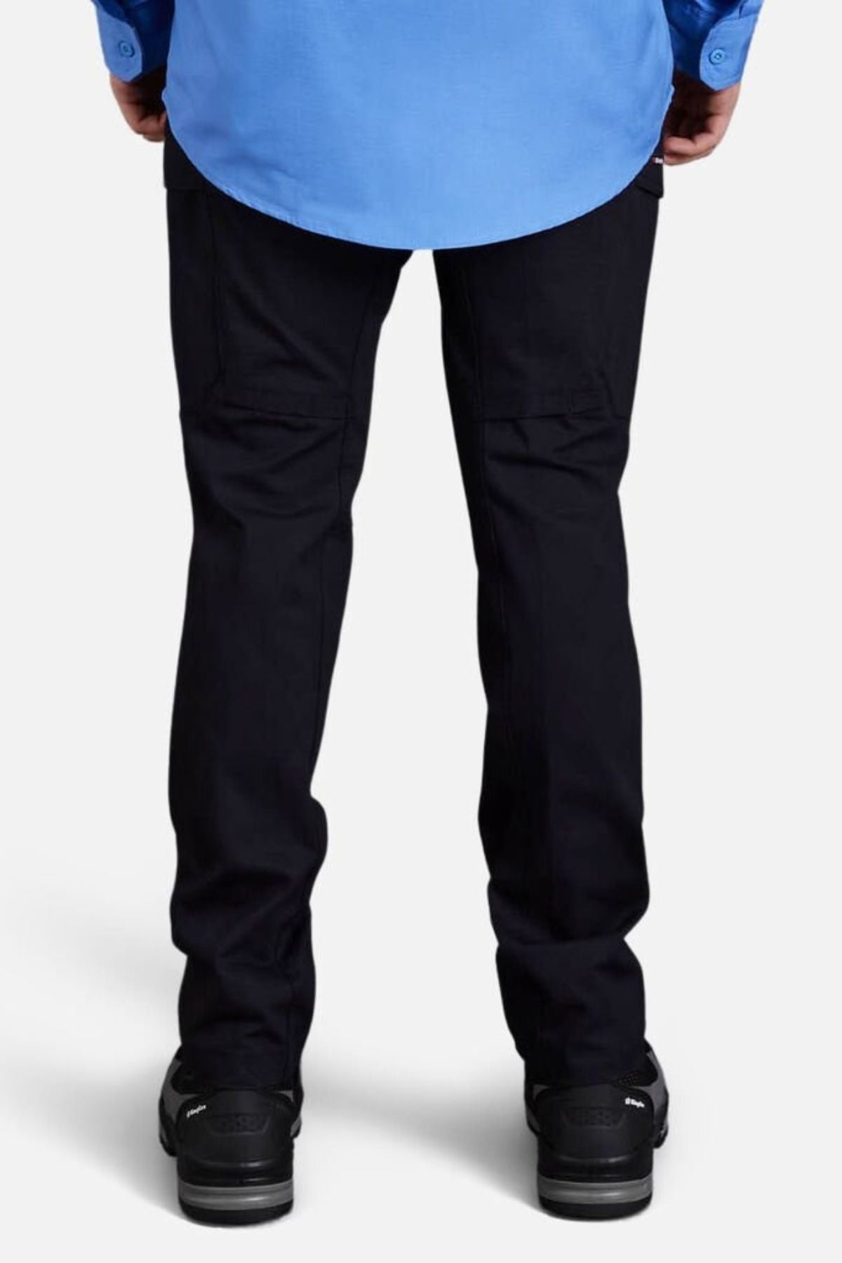 A person, seen from behind, wears a light blue shirt and King Gee Workcool Pro Stretch Cargo Pant with multifunctional pockets and black shoes, standing against a plain light background.