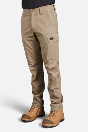 A person wearing King Gee Workcool Pro Stretch Cargo Pant with multiple pockets and brown work boots stands against a plain white background. Only the lower body is visible.
