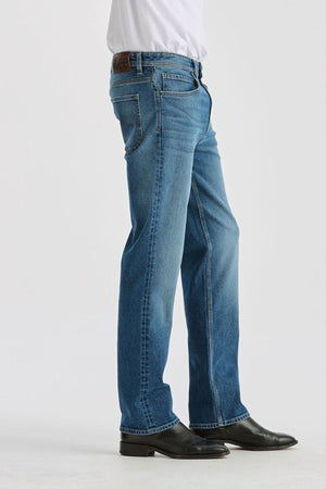 Wearing Lee Originals L101 Straight Jean in light blue, a white tucked-in shirt, and black leather shoes, a person stands against a plain white background with only the lower half of the body visible.