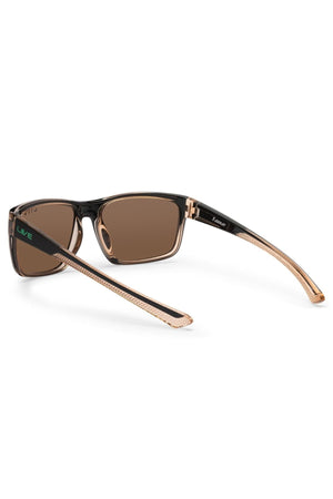 The Liive X Fairway X Sunglasses feature a classic profile with black frames, brown lenses, and translucent beige arms accented by the green "LIVE" logo. They offer stylish looks and premium UV protection for any casual wardrobe.