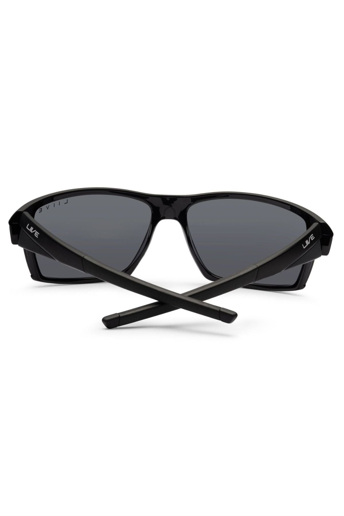 The Liive X Ignite X Sunglasses feature a black, sporty wrap-style frame with dark lenses and crossed arms, offering a sleek, modern silhouette and contemporary appeal.