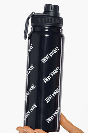 A hand holds the Lorna Jane Iconic Insulated Water Bottle, featuring a flip-top lid and "LORNA JANE" printed in white diagonal letters for a stylish look.