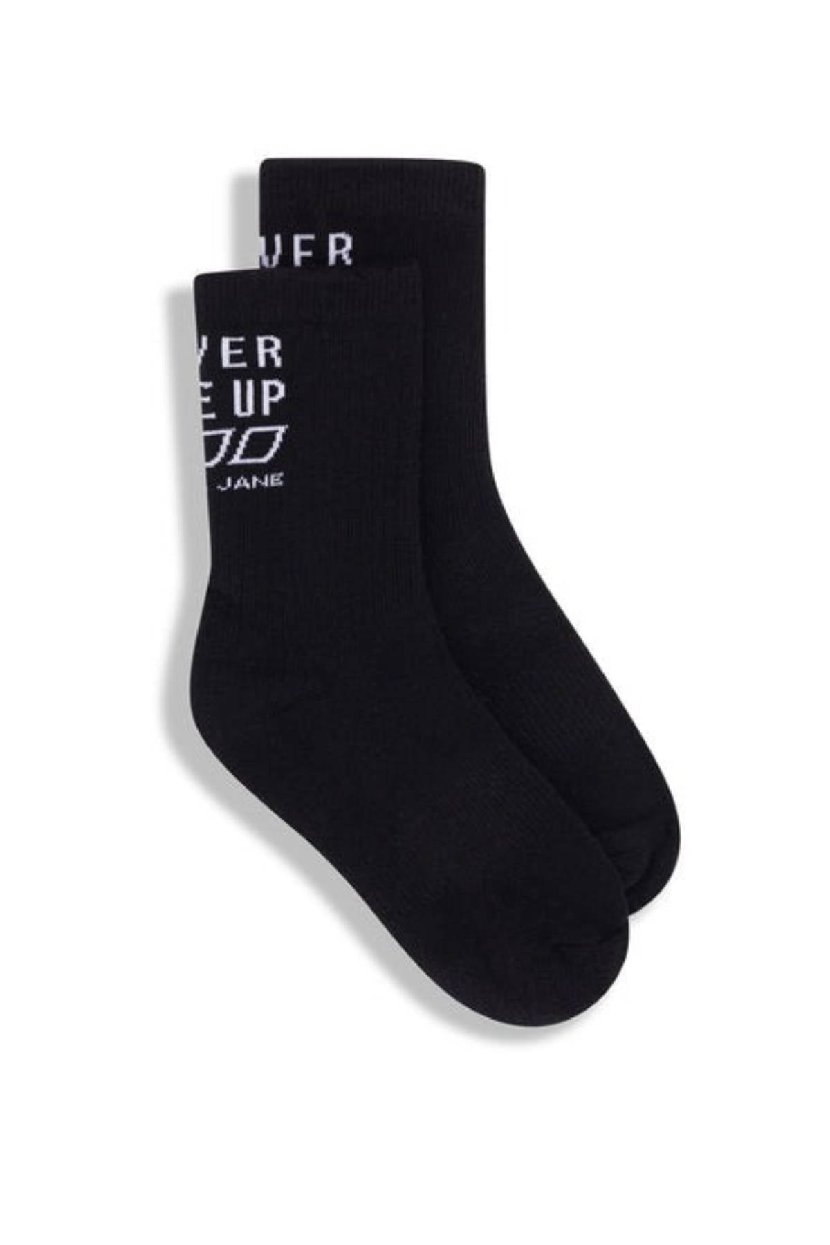 The Lorna Jane Never Give Up Arch Support Crew Socks are black crew socks with cushioned soles and "EVER UP" in white text on the upper side, shown overlapping each other on a plain white background.