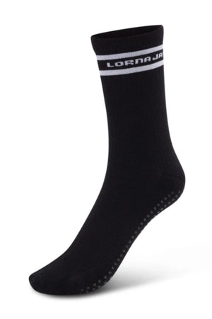 The Lorna Jane Pilates Grip Crew Socks are black with a white stripe and "LORNA JANE" near the top, plus small grip dots on the sole—ideal for Pilates. Only one crew-length sock is shown against a white background.