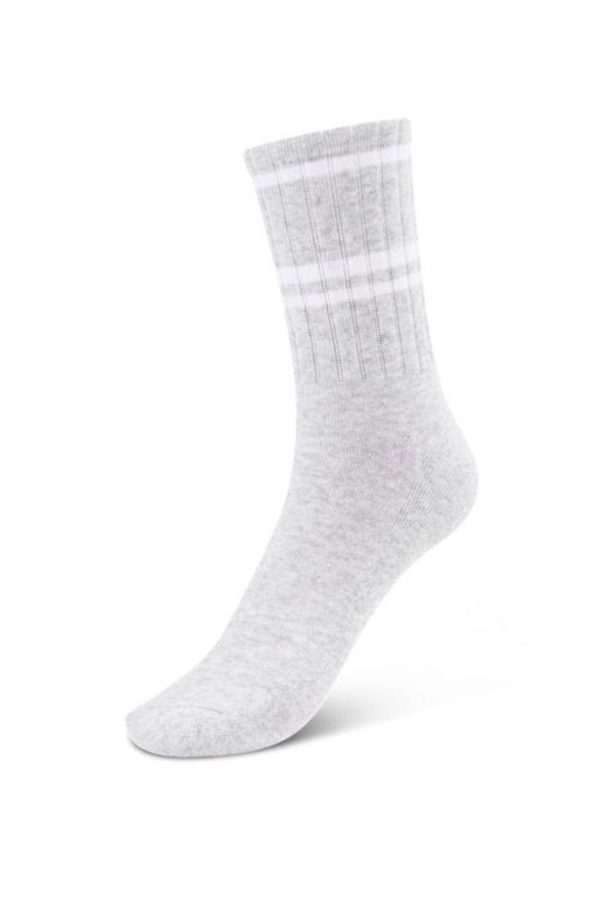 The Lorna Jane Lotus Crew Sock, shown upright on a white background, is light gray with ribbed texture and two white stripes near the top. Made from breathable cotton for comfort and sporty style.