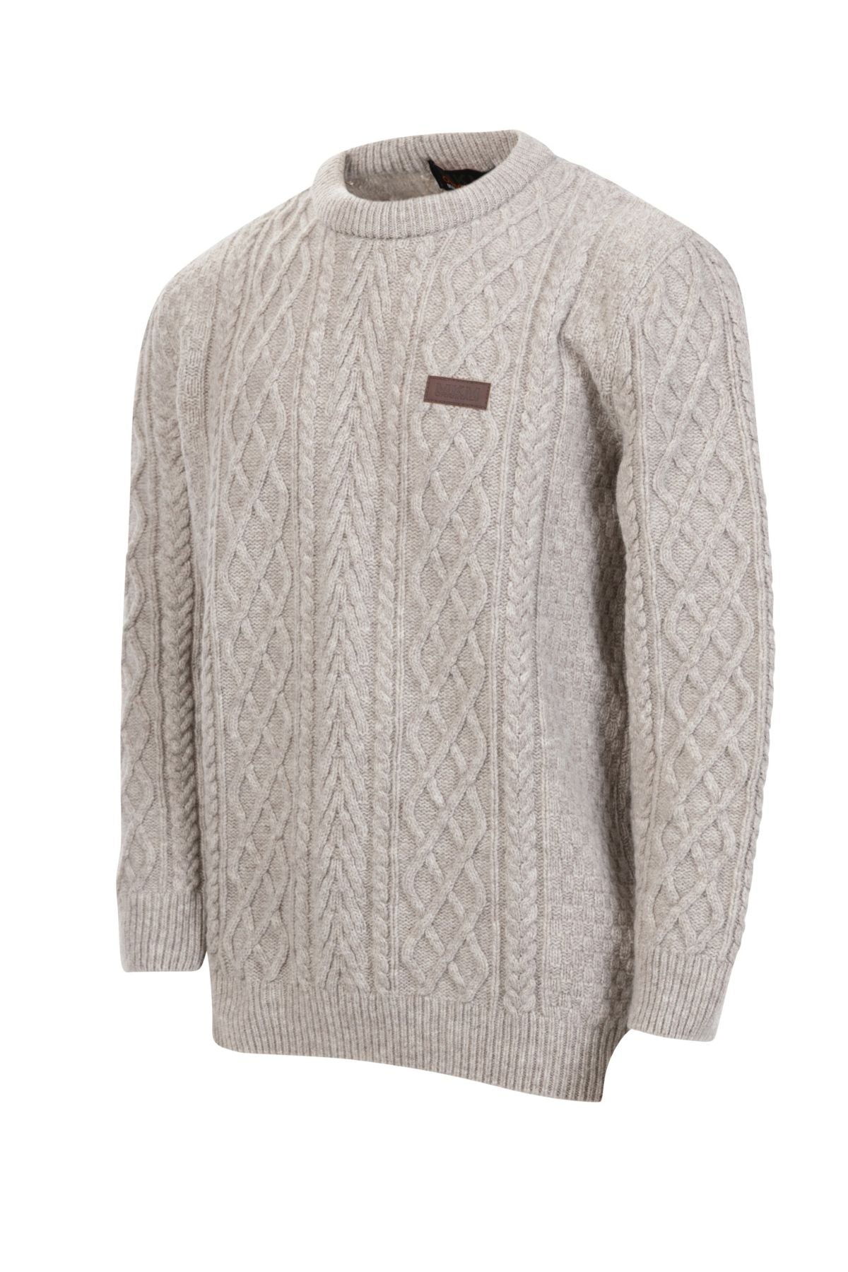 The MKM Highland Sweater in light gray is made from 100% New Zealand lambswool, with long sleeves, ribbed cuffs and hem, and a small brown rectangular patch on the left chest. Shown against a white background.