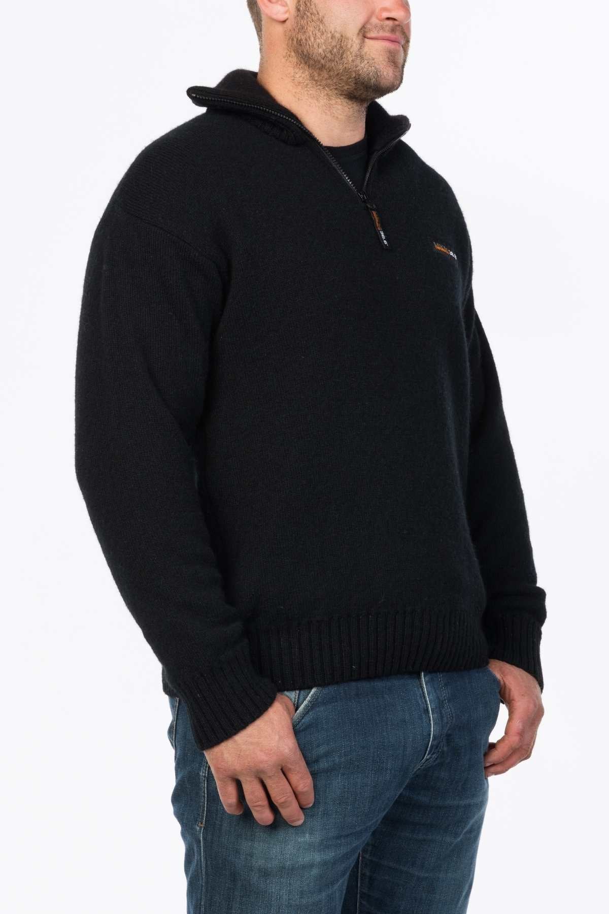 A man wearing the MKM Tasman Dual Layer Possum & Merino Knit sweater in black and blue jeans stands against a white background, facing slightly to the left.
