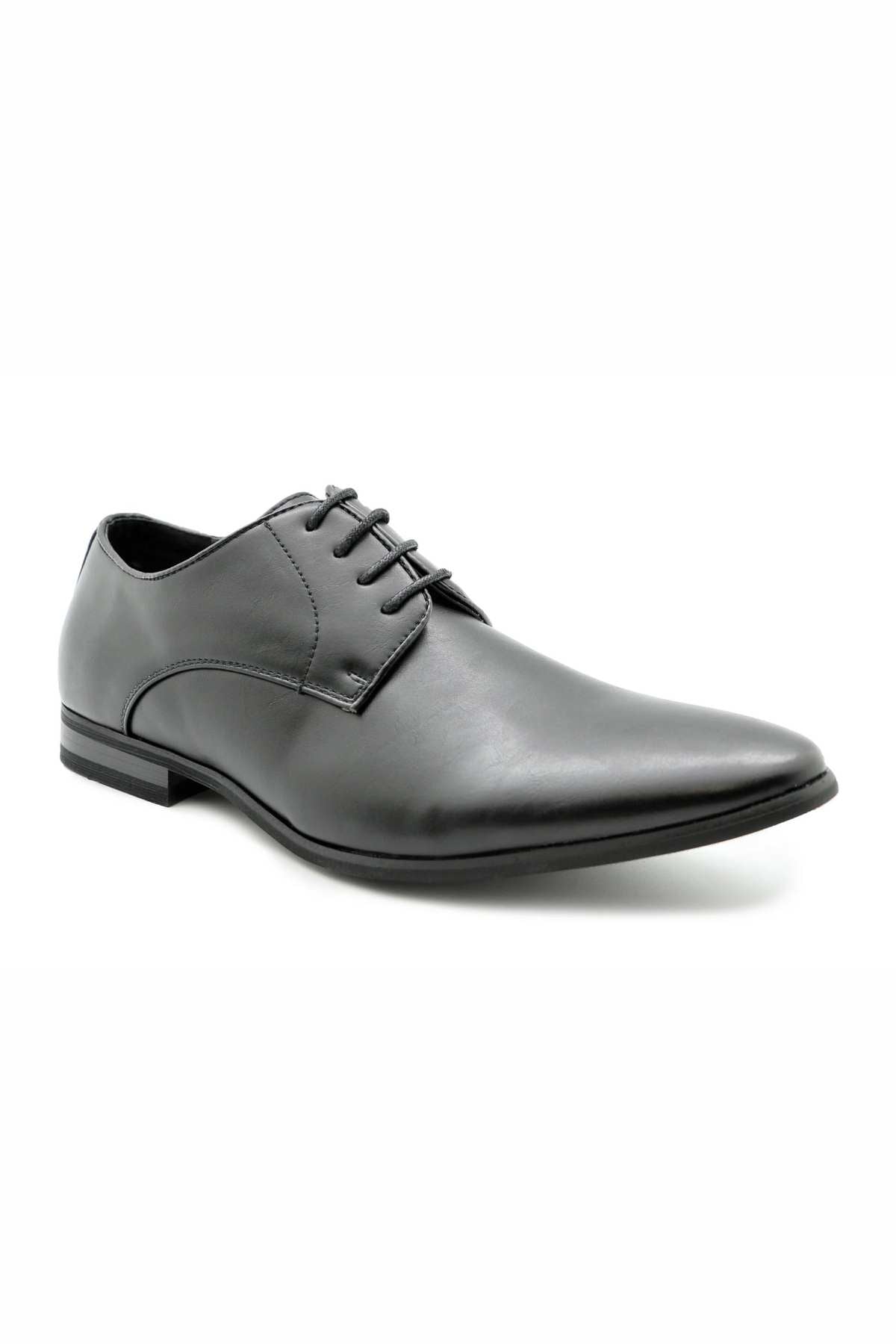 Against a white background, the elegant black Messa Pisa Shoe is displayed. This vegan-friendly shoe features a sleek, polished design with a slightly pointed toe and laced closure, making it suitable for formal occasions.