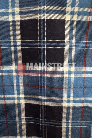 A blue, white, and black plaid pattern with thin red lines forms the classic tartan design of the Milton Open Front Flannelette Shirt. "MAINSTREET" is faintly visible across the center.