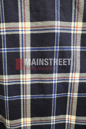 A close-up of navy blue plaid fabric with white, red, and beige lines from the Milton Open Front Flannelette Shirt. "MAINSTREET" and "shopping destination" are partially visible on the extra long tail.