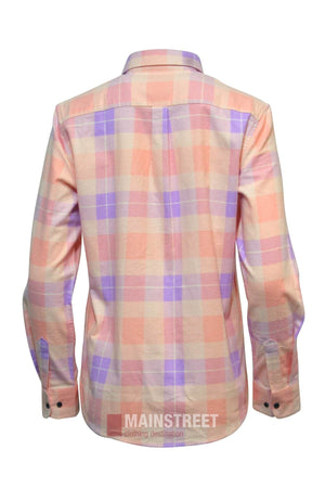 The Milton Ladies Flannelette Shirt features a pastel pink, purple, and cream plaid design. Made from high quality cotton, it has buttoned cuffs, a collar, and is tailored for women’s sizing. Shown here from the back.