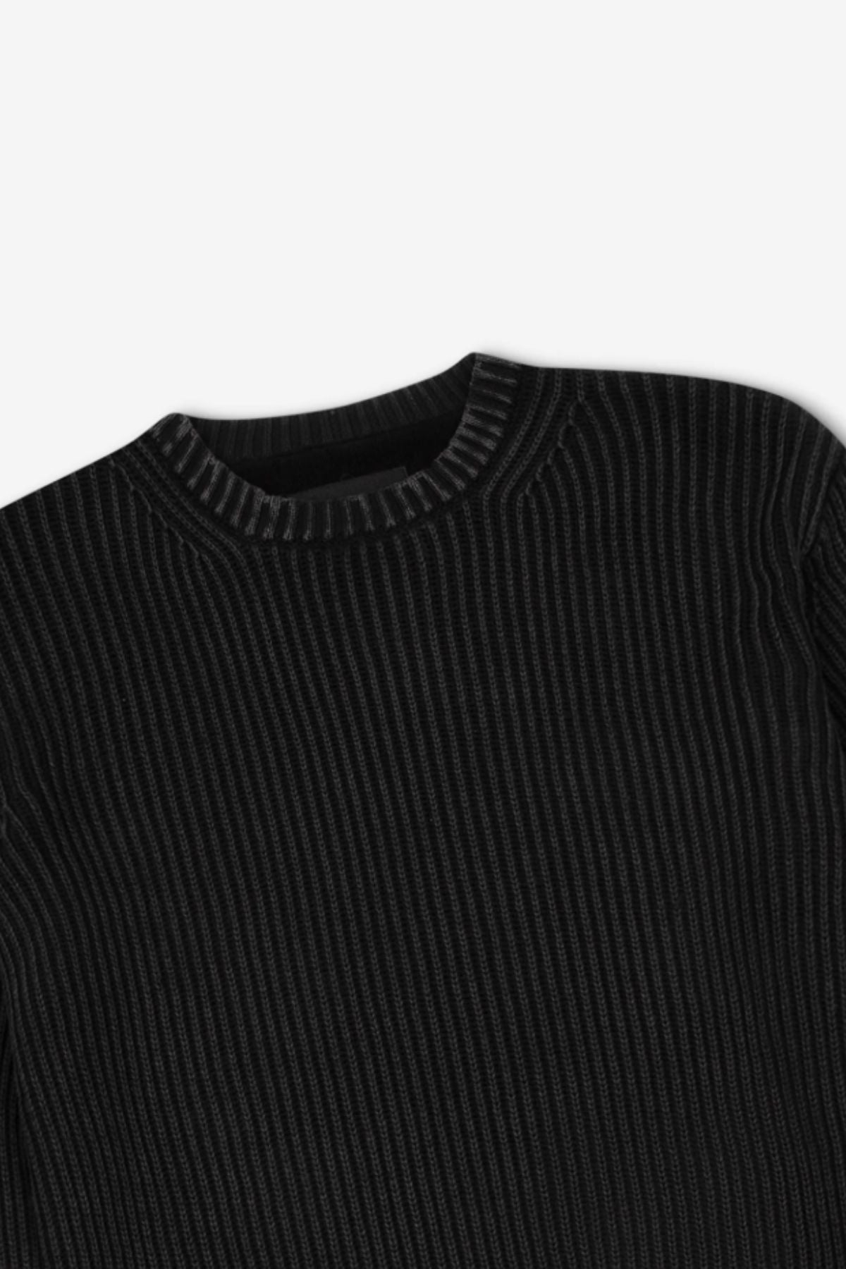 The Mr Simple Fisher Knit sweater, shown in black with a ribbed texture and round neckline, lies flat against a white background. Vertical ribs enhance its relaxed fit for a timeless style.