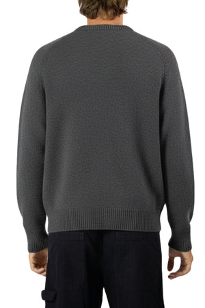 A person is shown from the back wearing a relaxed fit, textured dark gray Mr Simple Fred Knit 100% wool jumper and black pants against a white background—an ideal winter wardrobe addition.