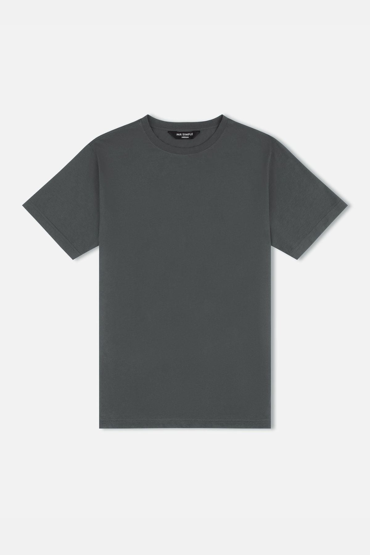 The Mr Simple Reginald Organic Tee is a plain T-shirt crafted from organic cotton in a dark gray hue. It includes short sleeves and a rounded neckline, highlighted against a white background, emphasizing its stretchy and durable design that is perfect for everyday wear.