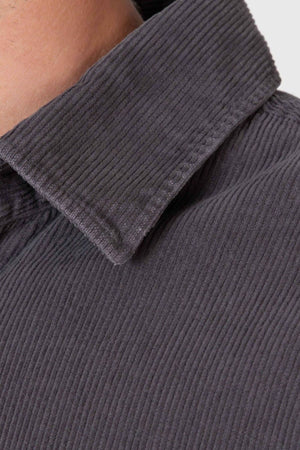 Close-up of a person wearing the Mr Simple Sawyer Cord Shirt in dark gray. The pointed collar and ribbed corduroy texture are clearly visible, with only the neck and shoulder partially shown.