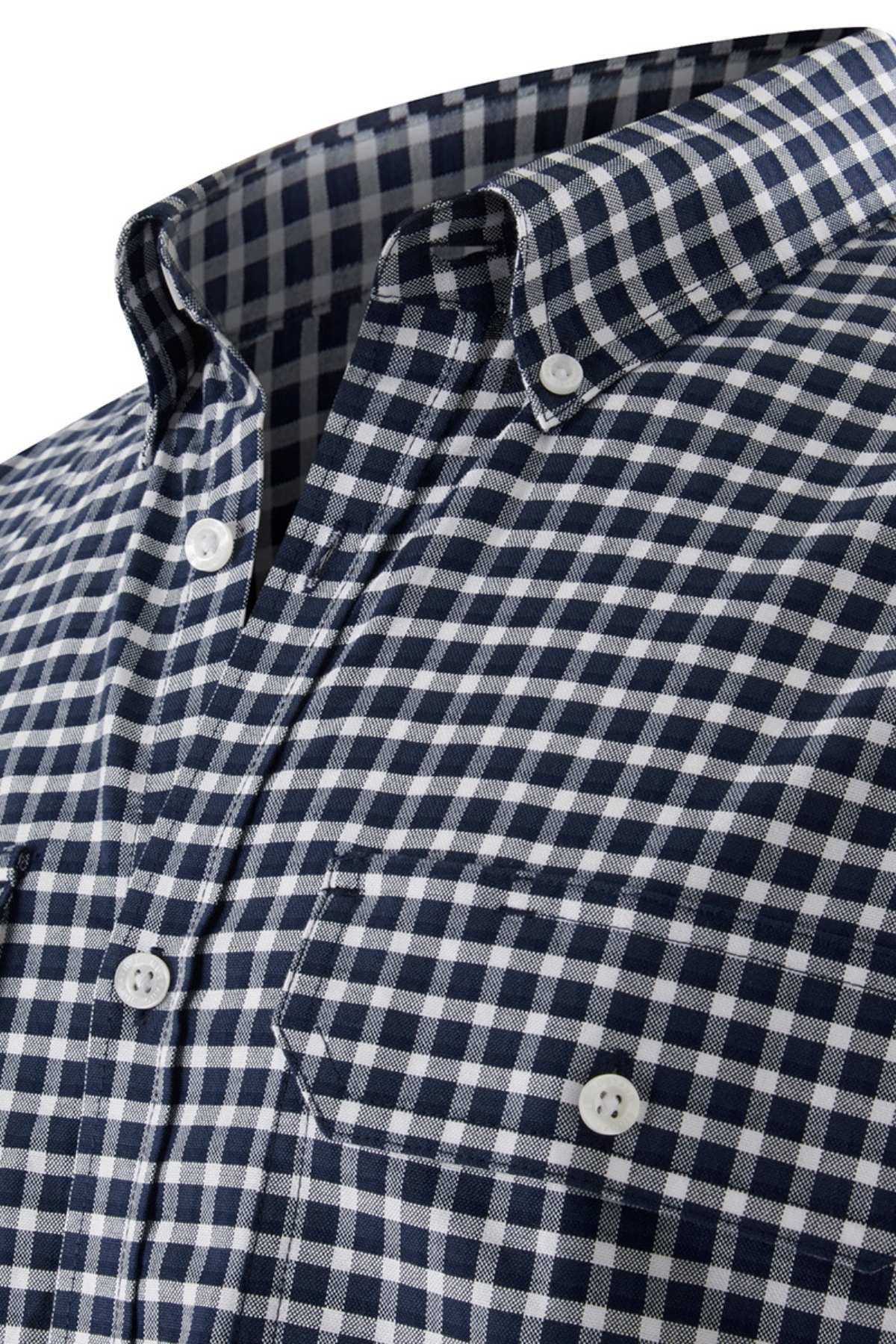Close-up of the Mustang Signature Check Shirt for men in blue and white, featuring a button-down collar, a front pocket with button closure, and a button-up front with white buttons. Made from high-quality cotton, this shirt showcases evenly spaced small squares.