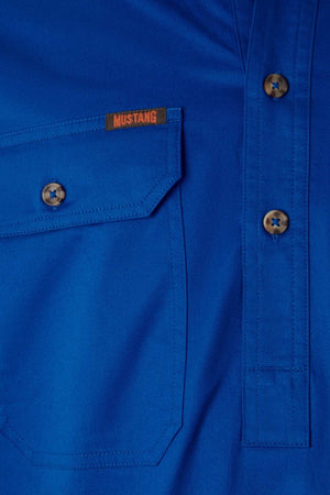 Close-up of the Mustang Signature Closed Front Workshirt in blue, featuring brown buttons, a front pocket, and an orange "MUSTANG" tag above the pocket that highlights its quality cotton fabric.