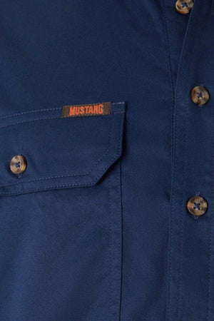 Close-up of the Mustang Signature Closed Front Workshirt in blue, featuring brown buttons, a chest pocket, durable cotton fabric, and an orange "MUSTANG" label above the pocket.