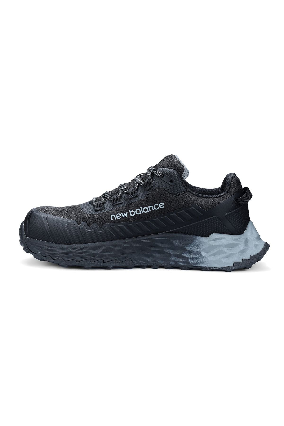 The New Balance Cremorne Safety Shoe is a black shoe with a composite toe, a textured gray slip-resistant sole, and "new balance" branding on the side, displayed in side profile against a white background.
