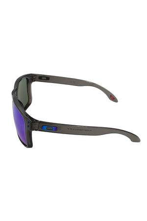 The Oakley Holbrook XL Polarized sunglasses feature gray frames with purple-tinted lenses, highlighted by sleek blue and red accents on the arms and hinges, shown from a side angle.