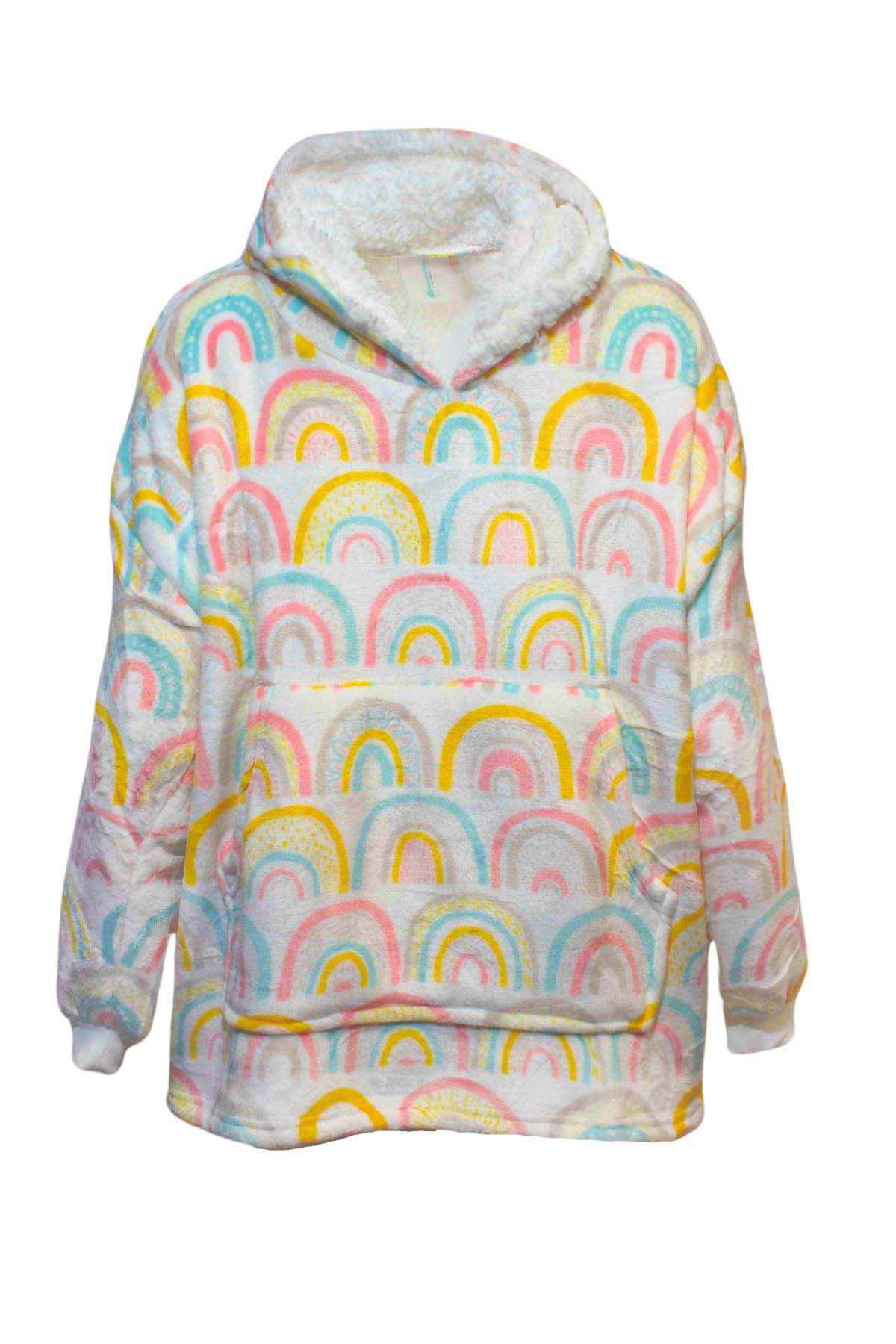 The Odyssey Kids Snoogie is a hooded, oversized sweatshirt featuring a colorful rainbow pattern in pastel shades of pink, blue, yellow, and white. It has a front kangaroo pocket and a plush, warm sherpa lining on the hood. The fabric appears soft and cozy, making it perfect for lounging.