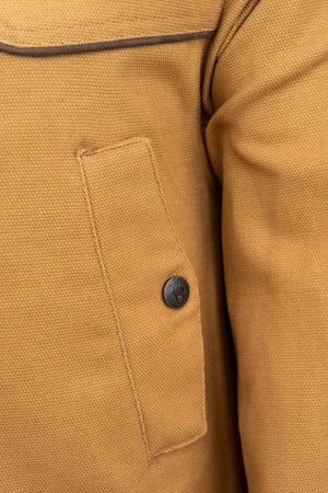 Close-up of an Outback Cattleman Jacket pocket featuring a flap secured by a black button. The fabric texture and seam details enhance its rugged charm, underscoring this multiple-pocket design as a reliable outdoor companion.