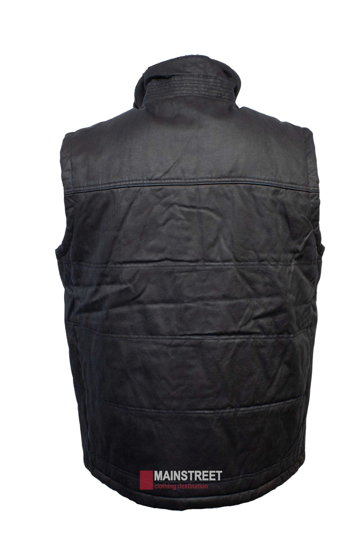 The Outback Heritage Oilskin Vest is black, sleeveless, and padded with a high Sherpa-lined collar. Displayed from the back, it features a red and white tag near the bottom reading "Mainstreet clothing destination." This weather-resistant vest offers warmth and style in any condition.