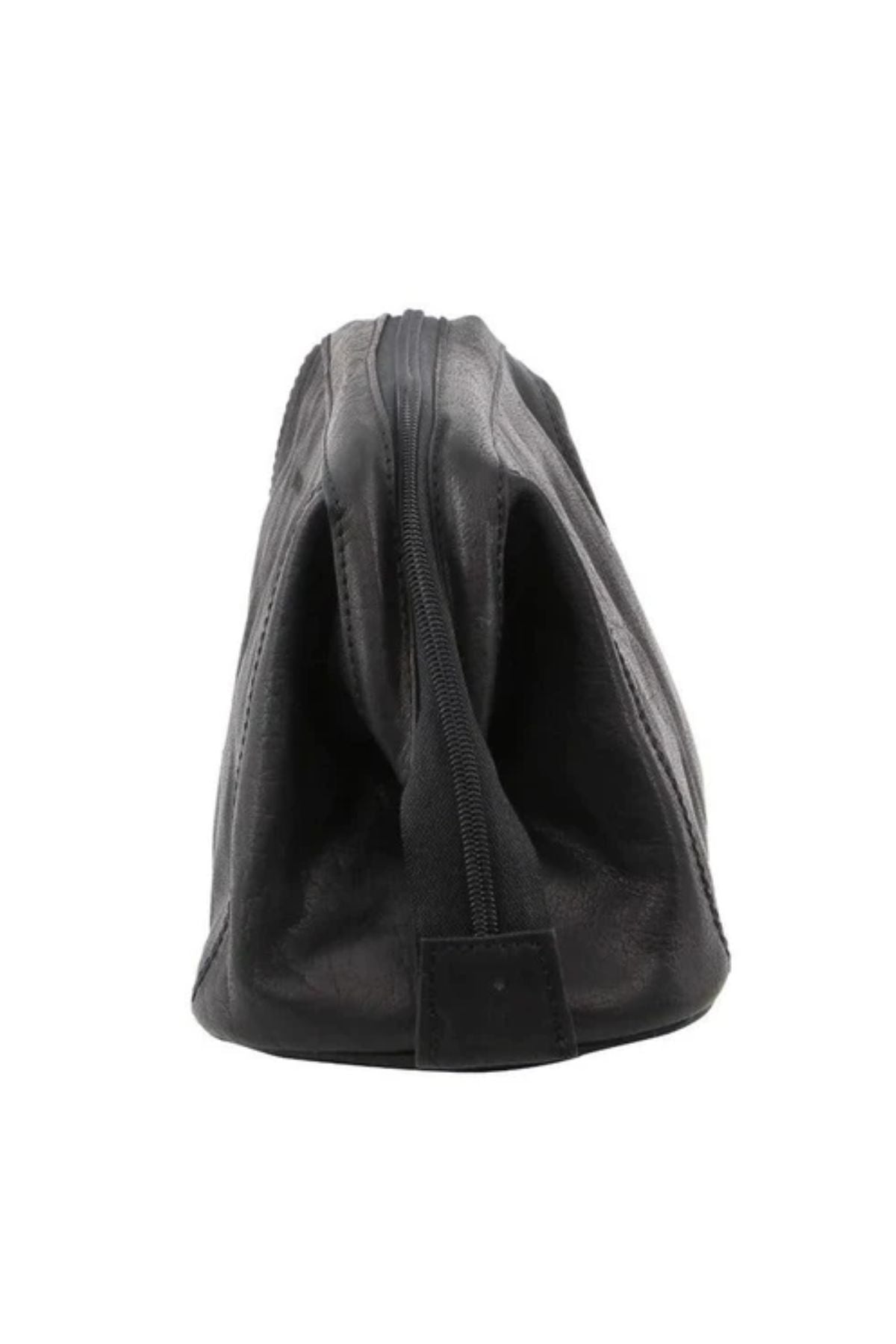 The Pierre Cardin Leather Toiletry Bag in black genuine leather stands upright in a side view, showing a top zipper. The travel toiletry bag appears empty and slightly collapsed.