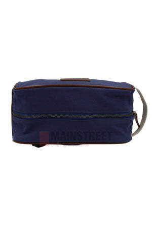 The Pilbara Toiletry Bag is a rectangular navy blue canvas bag with brown trim, a front zipper, and a gray fabric handle—ideal for organizing your travel essentials.