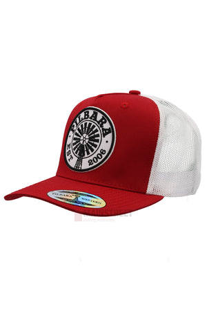 The Pilbara Western Established Cap is red and white with a breathable mesh back. It features a round embroidered patch on the front that reads "PILBARA EST 2006" with a windmill graphic at the center.