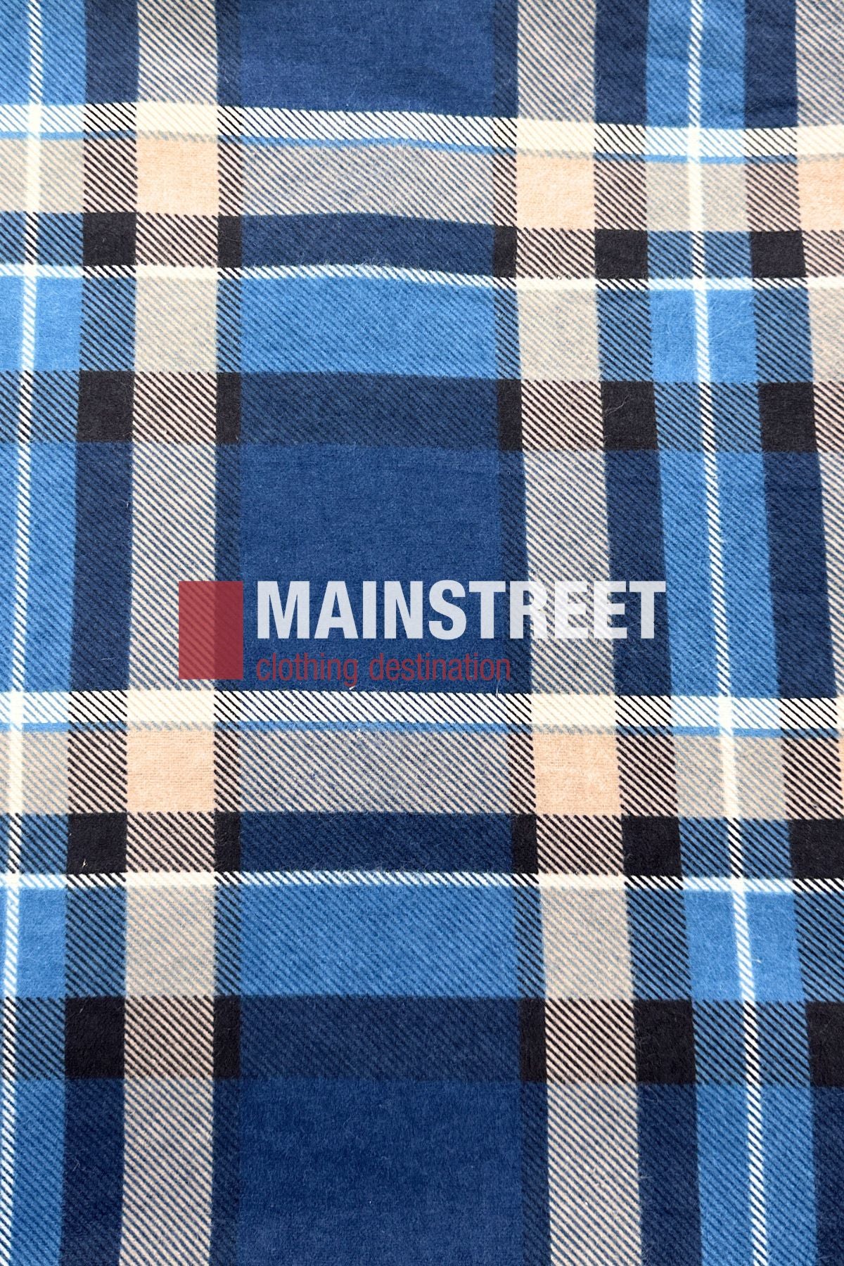 The Pilgrim Closed Front Flannelette Shirt features a blue, black, beige, and white plaid design in 100% cotton with "MAINSTREET clothing destination" boldly printed across the front in white and red letters.