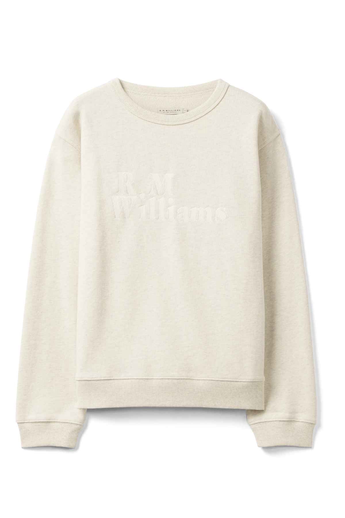 The RM Williams Women's Bold Heritage Sweatshirt in beige features an archive-inspired logo subtly embossed on the front. Designed with long sleeves and a crew neckline, it is made from organic cotton terry, offering a comfortable and casual style.
