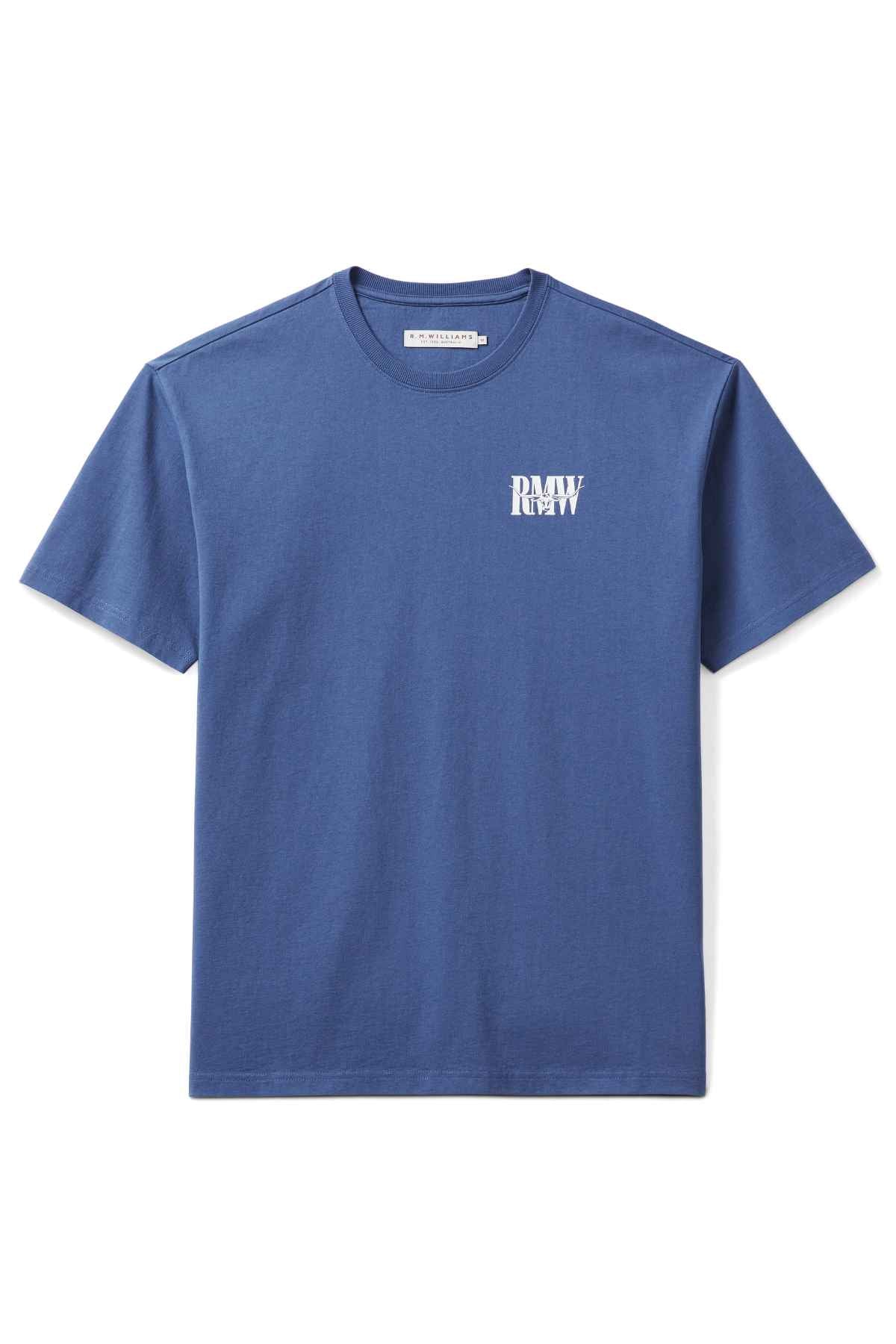 The RM Williams Classic Tee is a plain blue, short-sleeve t-shirt made from organic cotton. It features a small mirrored white "RAW" logo on the left chest and has a clean, subtle vintage style when laid flat against a white background.