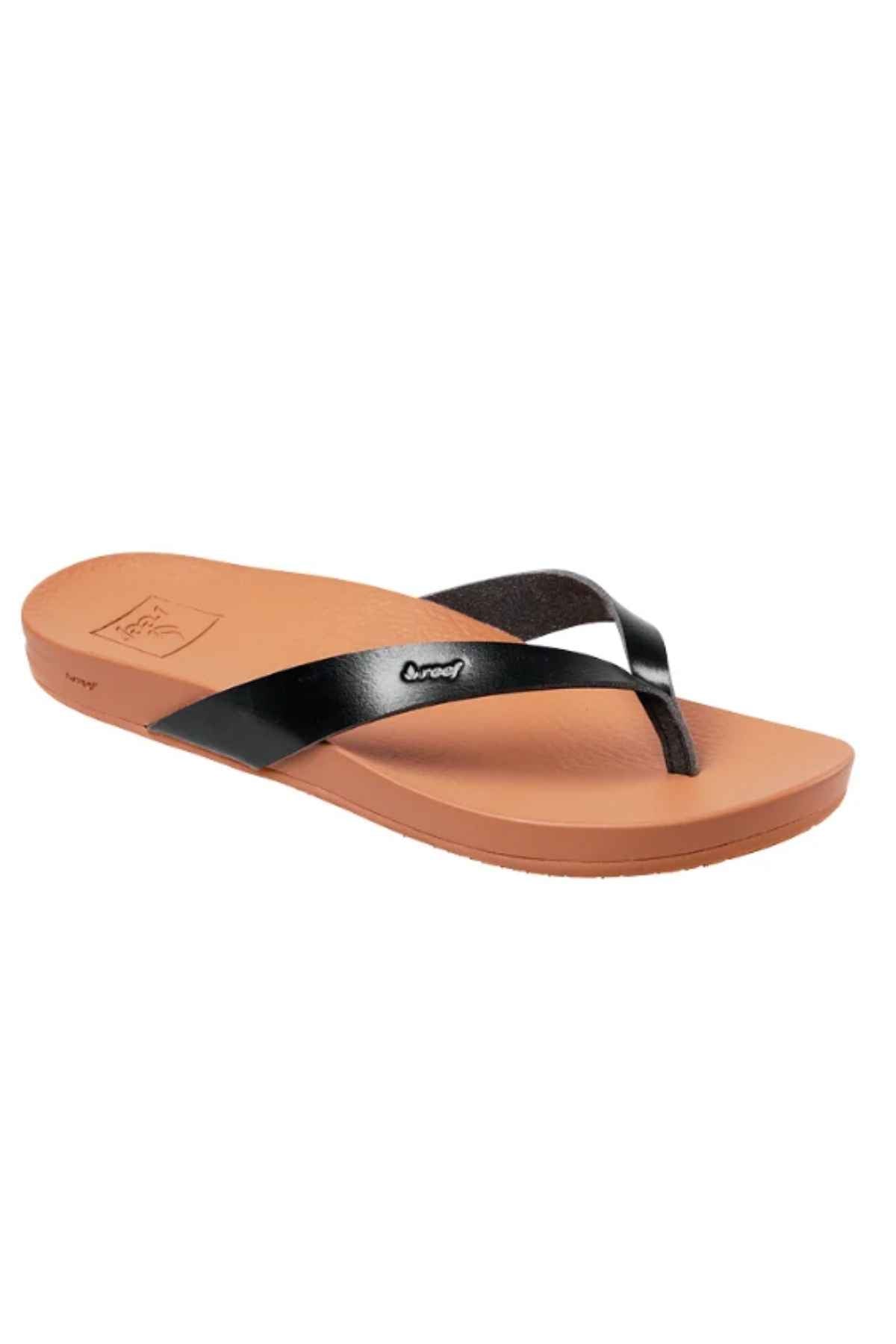 The REEF Cushion Court is a brown flip-flop sandal featuring a black glossy vegan leather strap. It offers subtle arch support with a simple footbed design and a low, flat sole, perfect for casual wear.