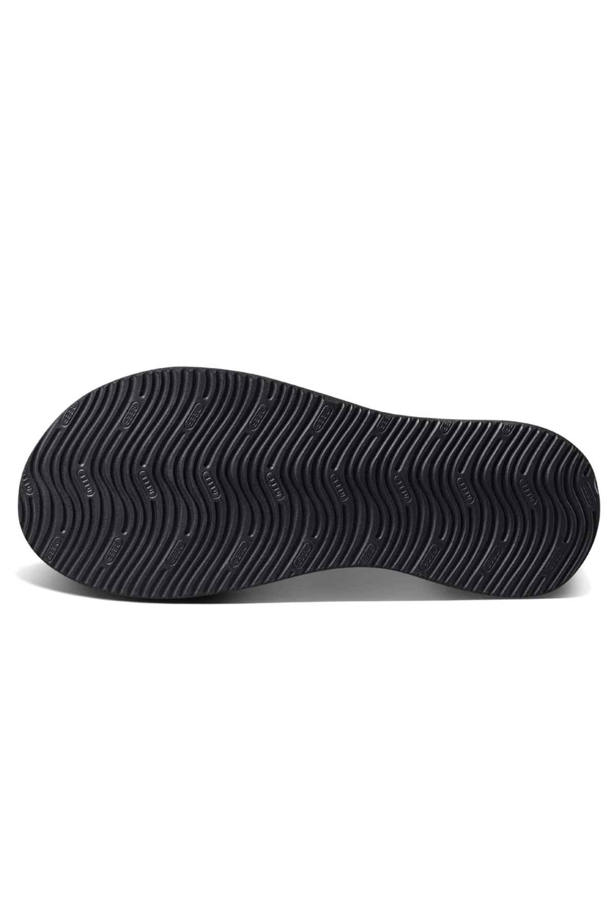 The REEF Cushion Phantom 2.0 features a black molded rubber outsole with a wavy, textured tread pattern and small circular logos, shown on a white background.