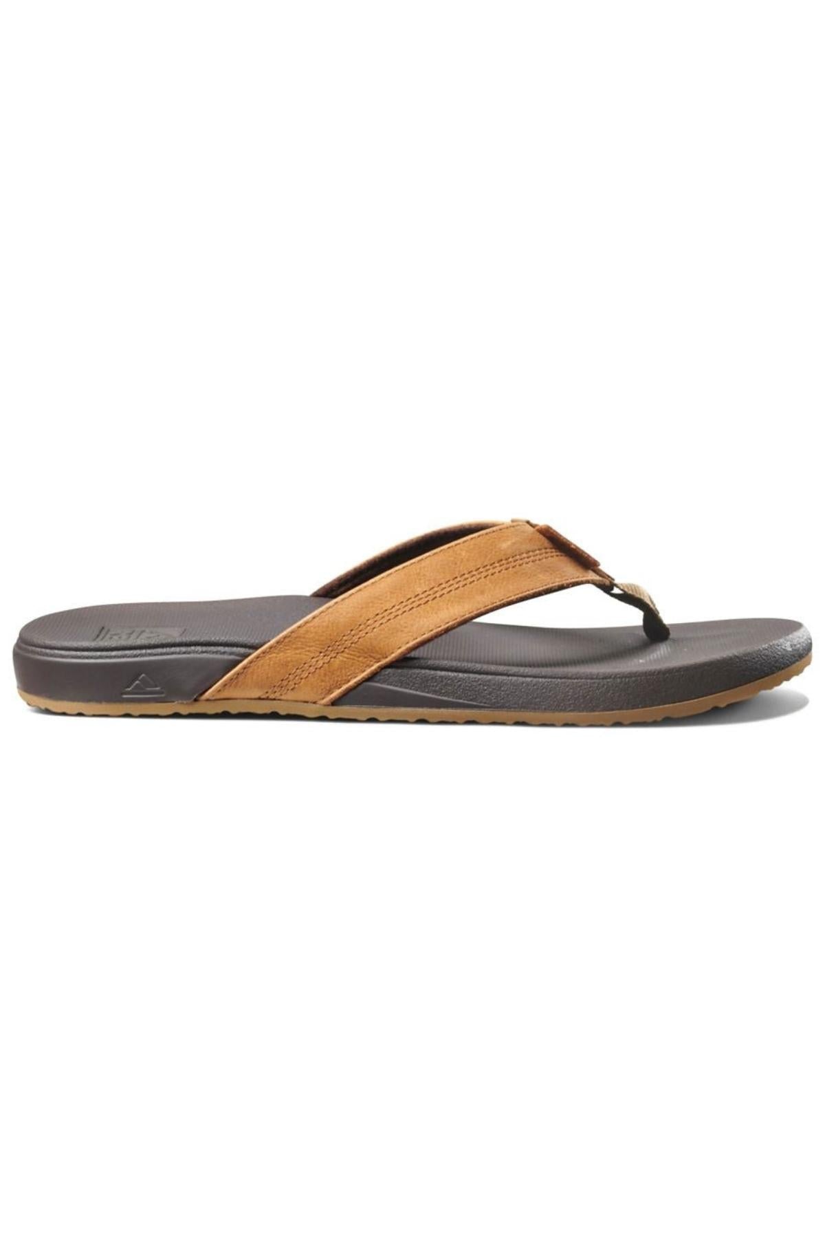 The REEF Cushion Phantom LE thong sandal, shown in side profile on a white background, features a brown and black design with a thick full grain leather strap and a dark cushioned footbed sole.