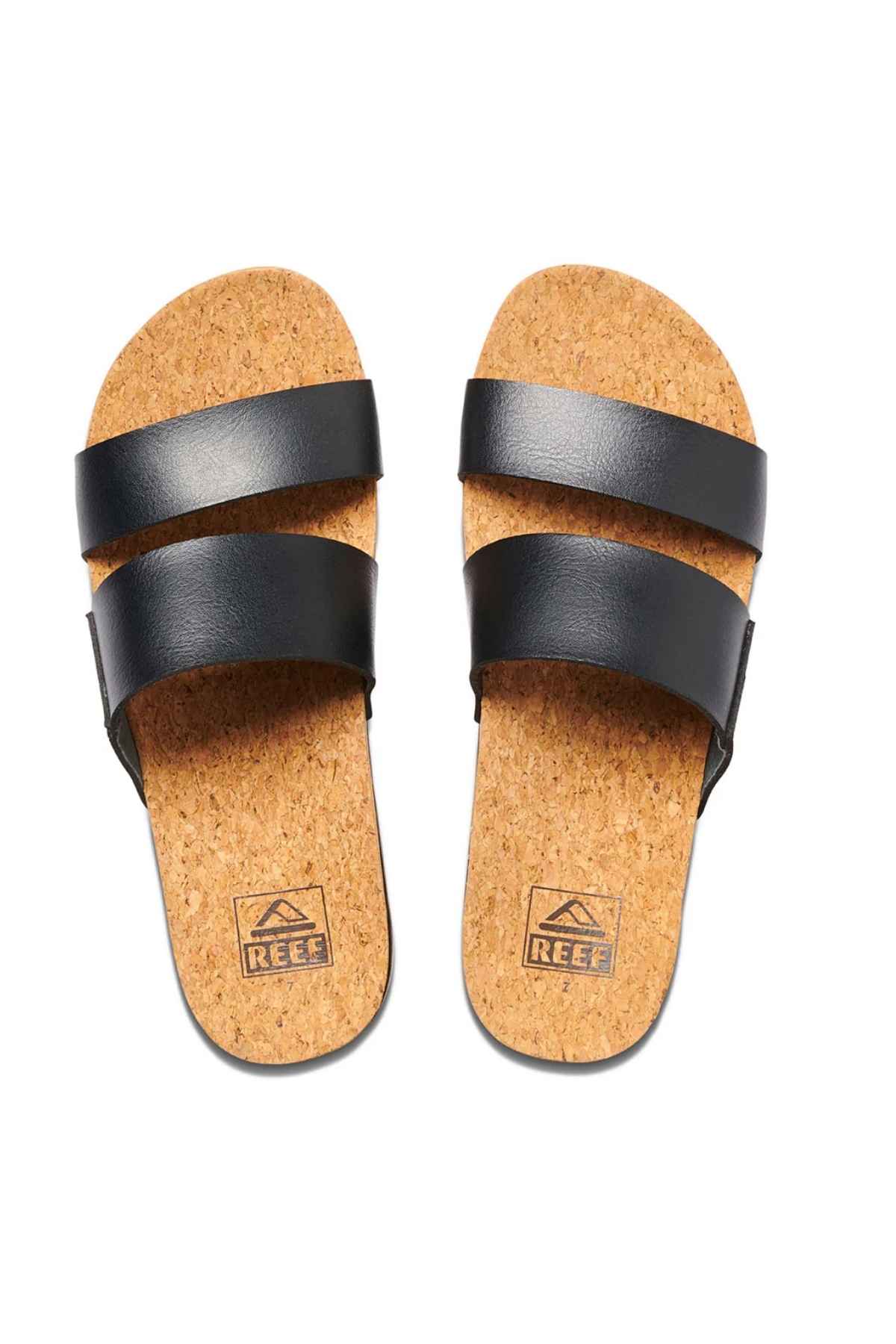 The REEF Cushion Vista Hi black sandals have two wide straps, a cushioned midsole, and a cork insole with arch support. The brand logo is visible, combining comfort and style for all-day wear.