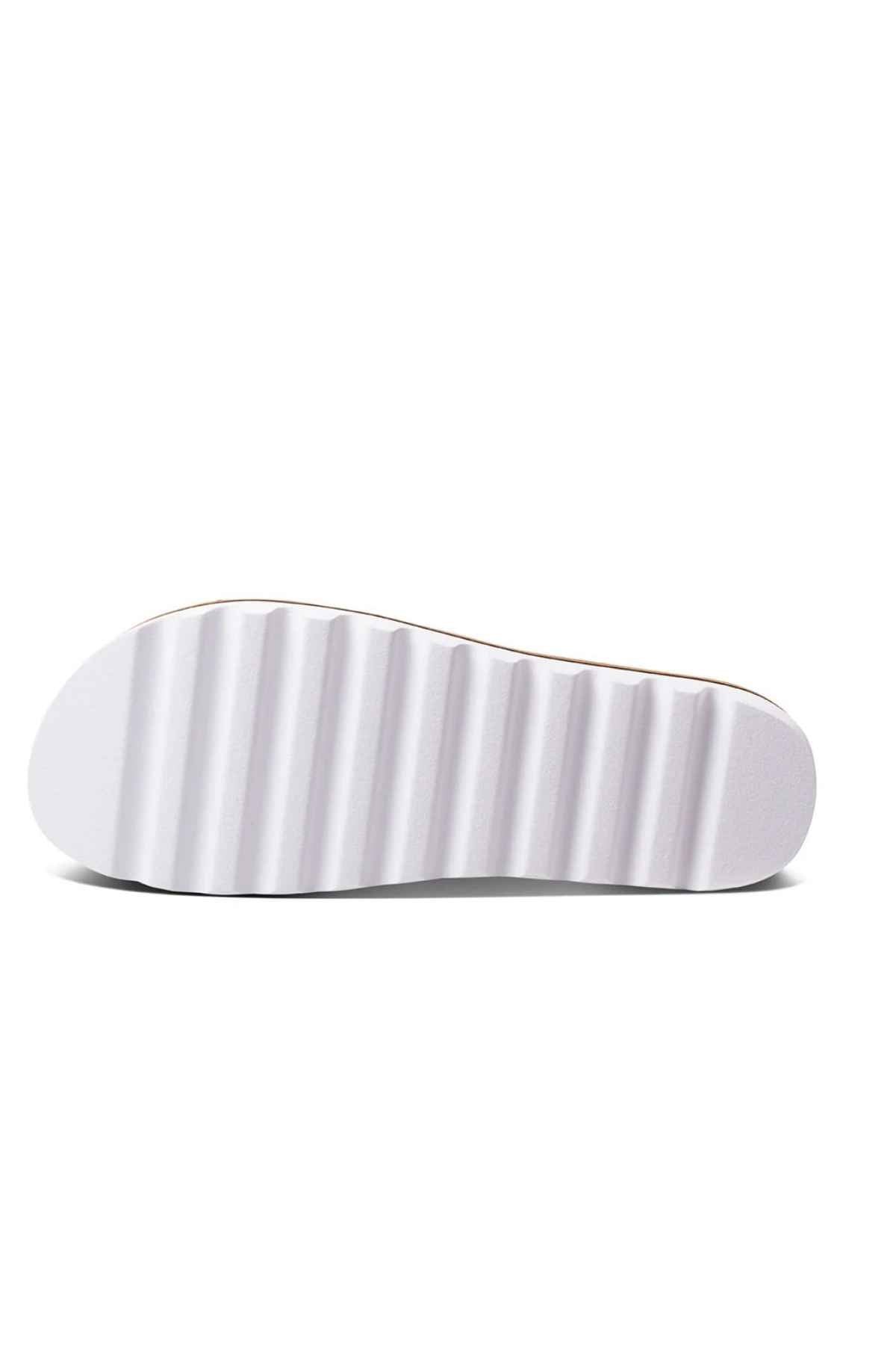 The image displays the sole of a REEF Cushion Vista Hi shoe in white, featuring a ridged pattern with horizontal grooves and a cushioned midsole for enhanced comfort.