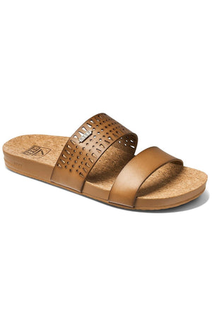 The REEF Cushion Vista Perforated brown slide sandal has two straps; the top one features circular perforations. The cork-textured footbed and flat sole offer comfort with excellent arch support, ideal for all-day wear.