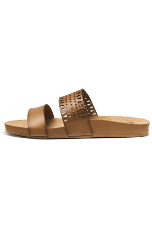 The REEF Cushion Vista Perforated sandal features a cork sole and brown slide design with two foot straps: one plain and the other with a perforated geometric pattern, providing arch support for minimalist, casual comfort.