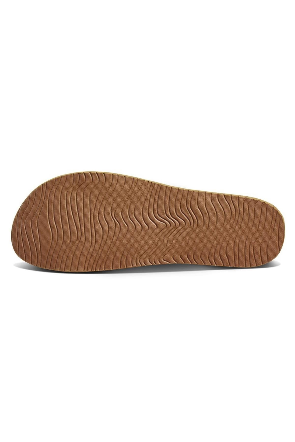 The image displays the bottom view of the REEF Velcro Vista SE sandal with a brown, wavy-patterned, non-slip sole. It includes premium leather straps and a cushion bounce midsole for enhanced comfort.