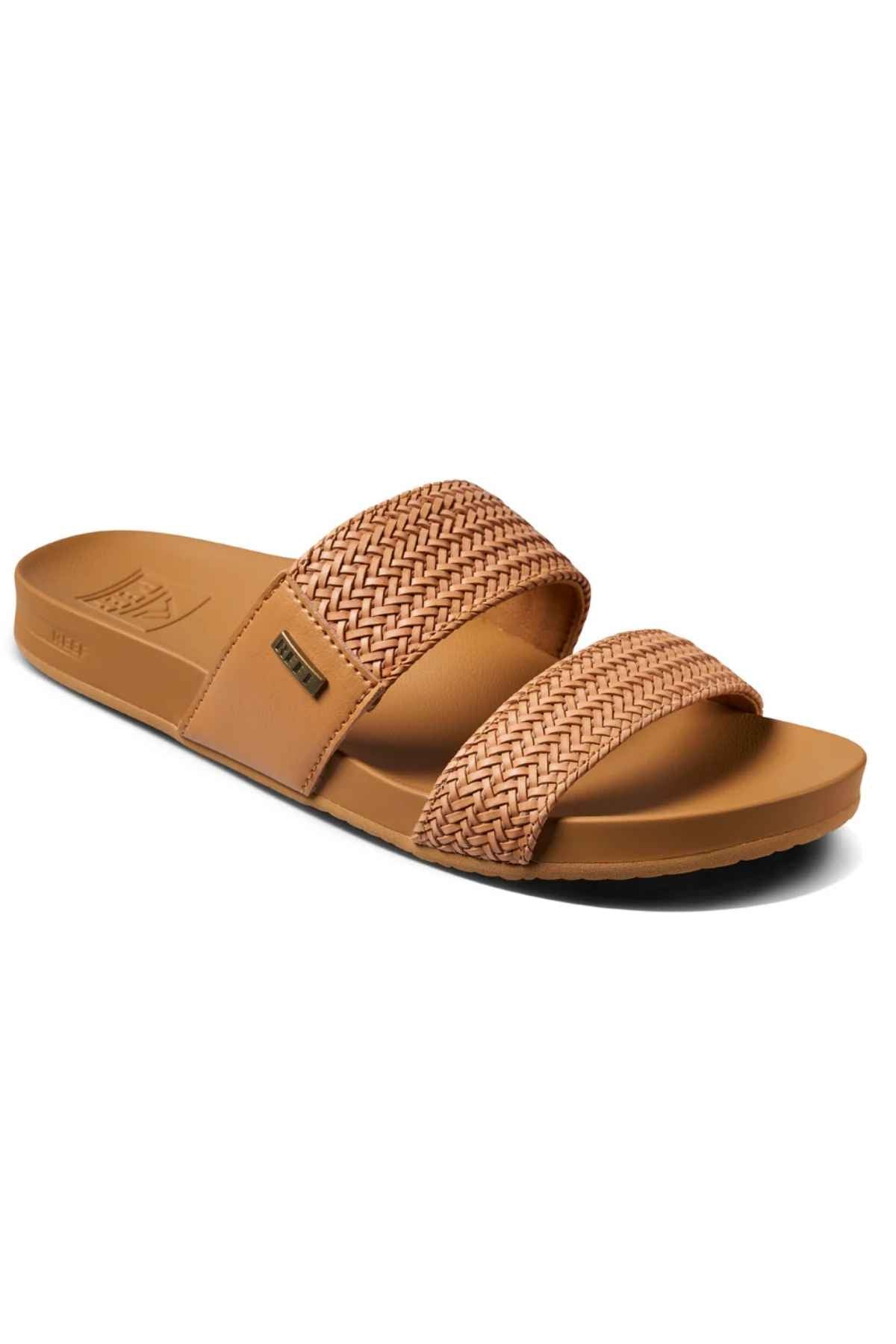 The REEF Vista Braid II brown slide sandal has two woven straps, a cushioned midsole for comfort, and the brand logo on the upper strap. Its casual design combines style with sustainability using eco-friendly materials.