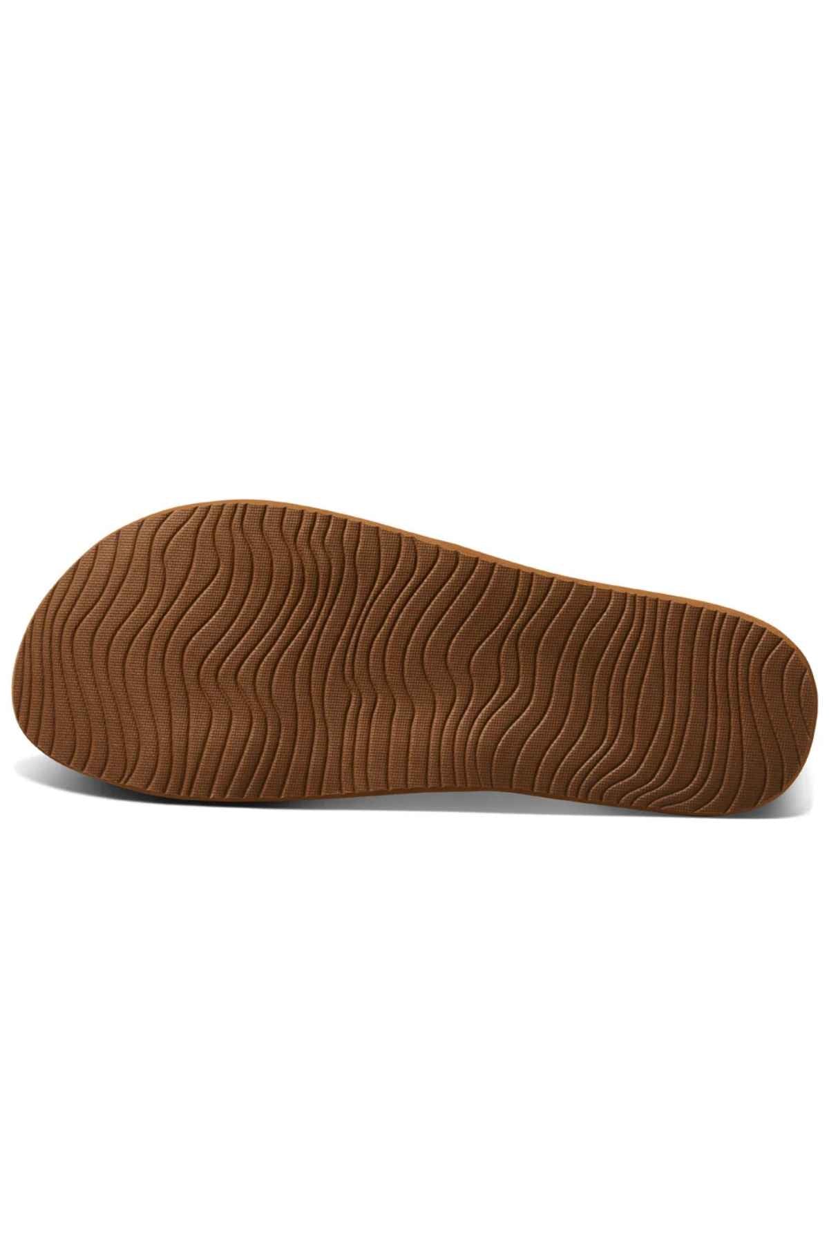 The image displays the eco-friendly brown rubber sole of the REEF Vista Braid II, photographed from below to showcase its wavy, textured tread pattern designed for excellent grip and traction.